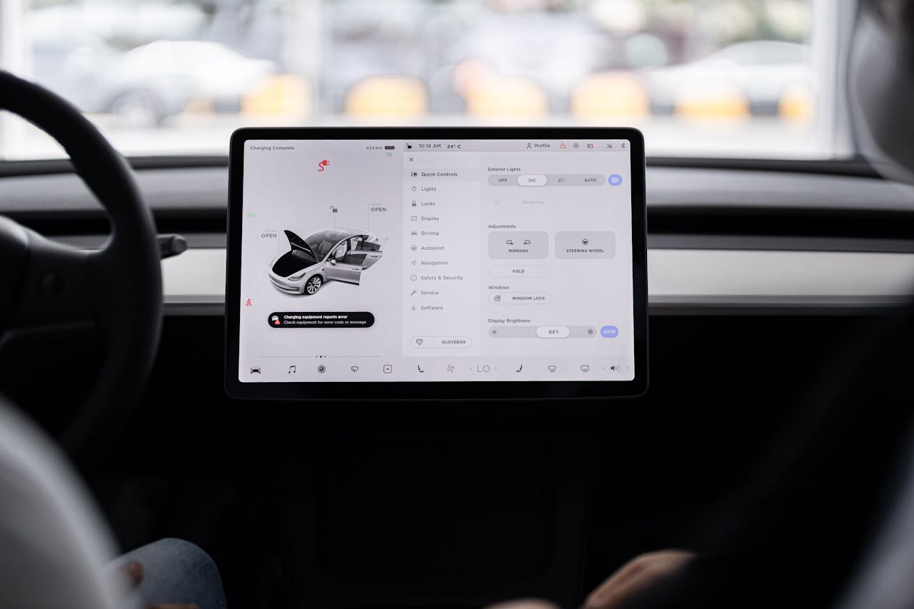 View of a modern car's dashboard featuring a digital display panel with control options.