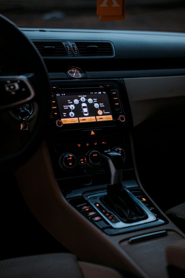 Stylish car interior featuring a modern dashboard with illuminated controls and touchscreen display.