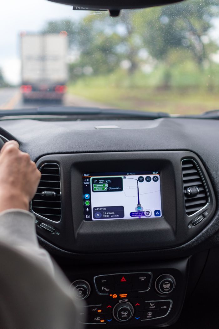 The Art of Drawing Readers In: Your attractive post title goes here View of GPS navigation screen inside a moving car with driver on the road.